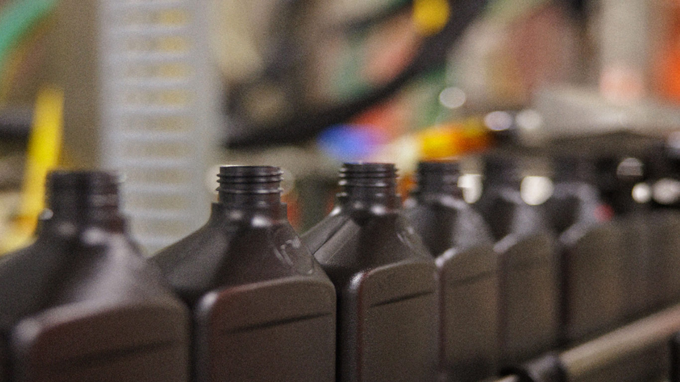 Plastic bottles moving along a production line in a manufacturing facility.